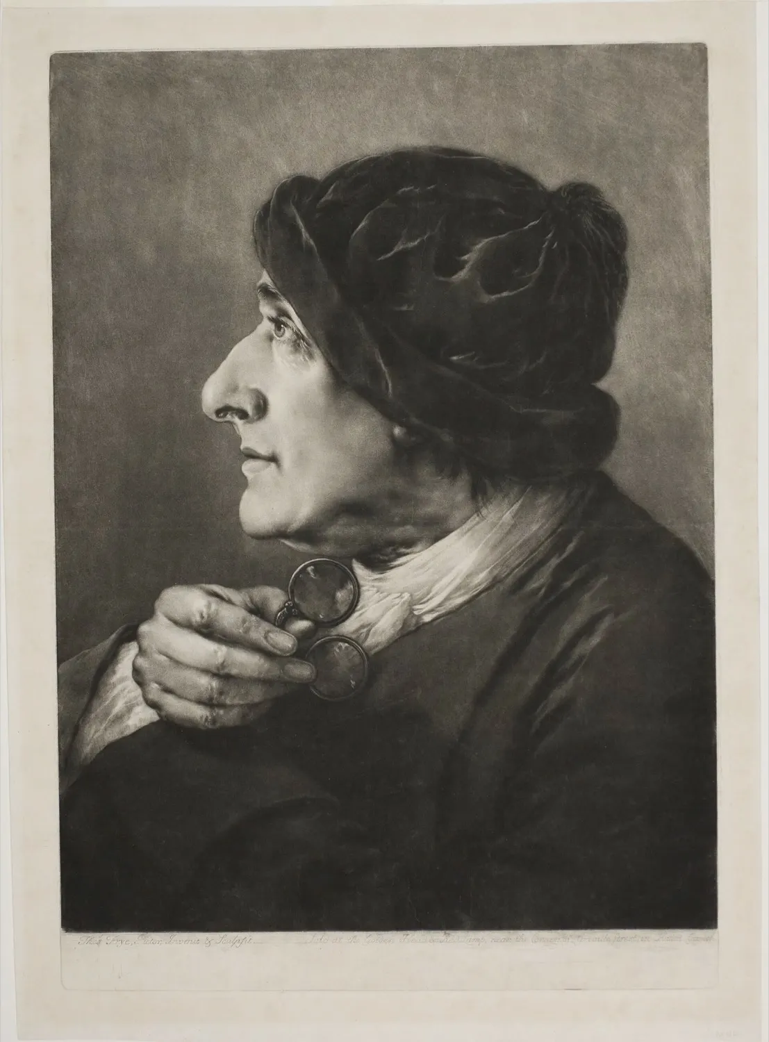 An eighteenth-century mezzotint of an old man wearing round spectacles